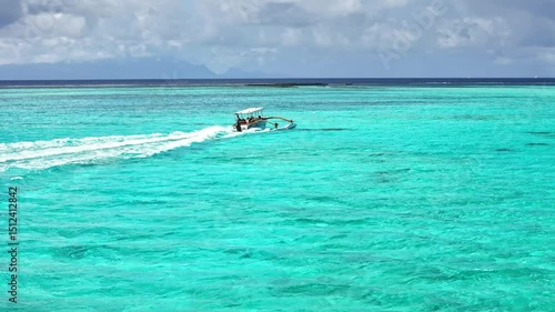 Drone aerial Tahiti. Aerial view of Bora Bora turquoise crystal clear water lagoon, tour sail boat. French Polynesia 4k.  Luxury honeymoon vacation, romantic getaway, exotic resort destination. 