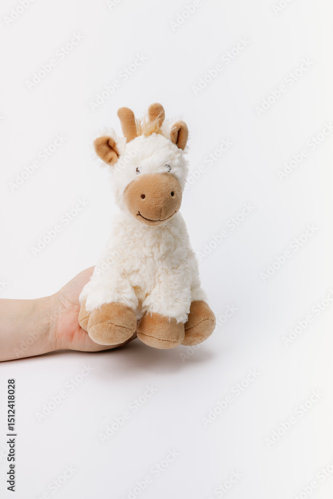 Baby giraffe stuffed animal sitting on a white background Baby giraffe stuffed animal sitting on a white background
