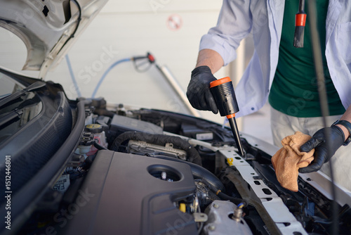 Canvas Print Car maintenance involves checking oil levels and ensuring engine is clean