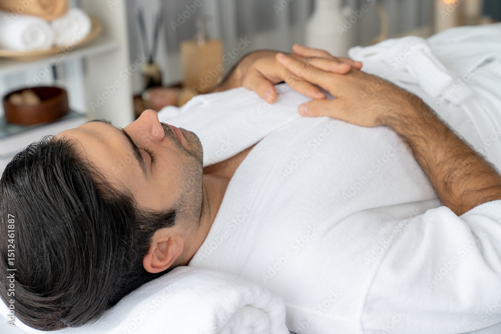 Caucasian man customer enjoying relaxing anti-stress spa massage and pampering with beauty skin recreation leisure in day light ambient salon spa at luxury resort or hotel. Quiescent Caucasian man customer enjoying relaxing anti-stress spa massage and pampering with beauty skin recreation leisure in day light ambient salon spa at luxury resort or hotel. Quiescent