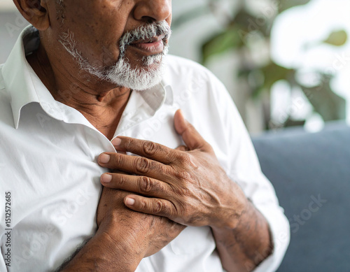 Elderly man experiencing chest pain discomfort