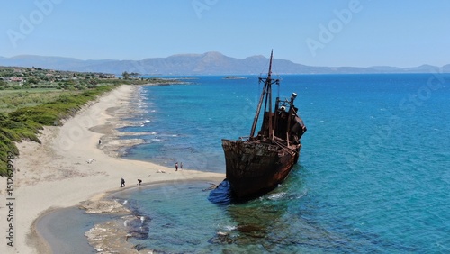 Abandoned shipwreck Dimitrios rests on a serene beach surrounded by clear blue waters in Gytheio Greece
