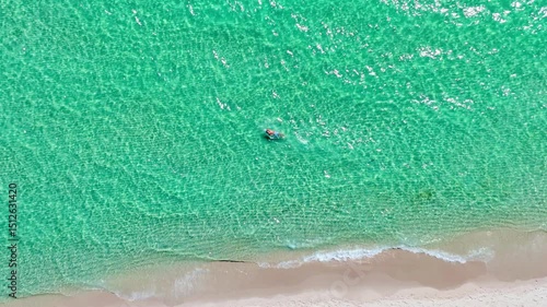 Slow motion video of a swimmer swimming in the ocean