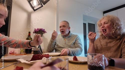 Three generations of a happy family — grandmother, grandfather, mother, and daughter — celebrating the little girl’s birthday together at home, enjoying a warm and joyful moment.