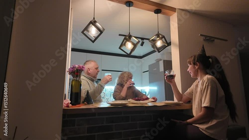 Three generations of a happy family — grandmother, grandfather, mother, and daughter — celebrating the little girl’s birthday together at home, enjoying a warm and joyful moment.