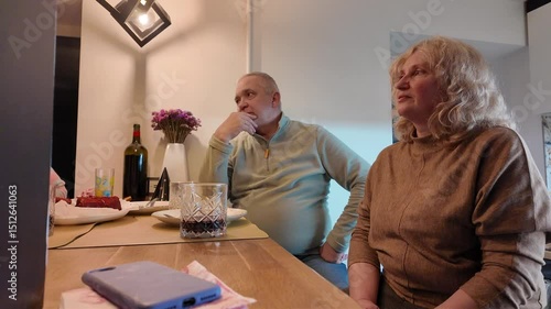 Three generations of a happy family — grandmother, grandfather, mother, and daughter — celebrating the little girl’s birthday together at home, enjoying a warm and joyful moment.