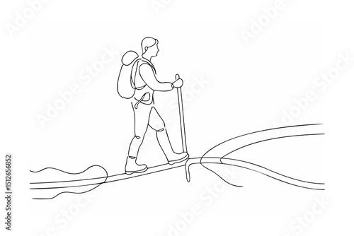 Hiker trekking across a narrow mountain path with backpack and trekking poles