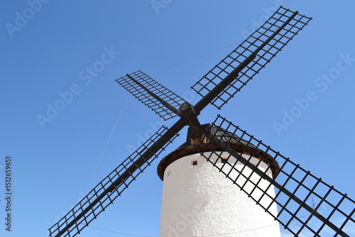 Picturesque spanish windmill against clear blue sky for travel and architecture enthusiasts. Campo de Criptana. La Mancha. Spain