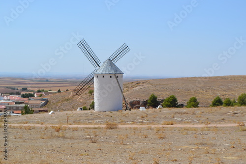 Traditional spanish windmill in rural landscape with clear blue sky. Campo de Criptana. La Mancha. Spain