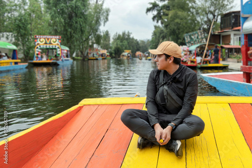 Enjoying a tranquil moment on a trajinera in Xochimilco, Mexico with vibrant colors