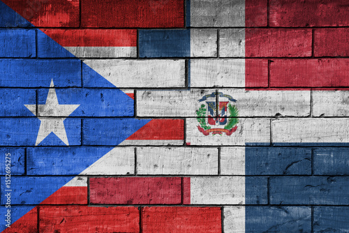 colourful painted big national flag of puerto rico and flag of dominican republic on a massive old brick wall background. concept