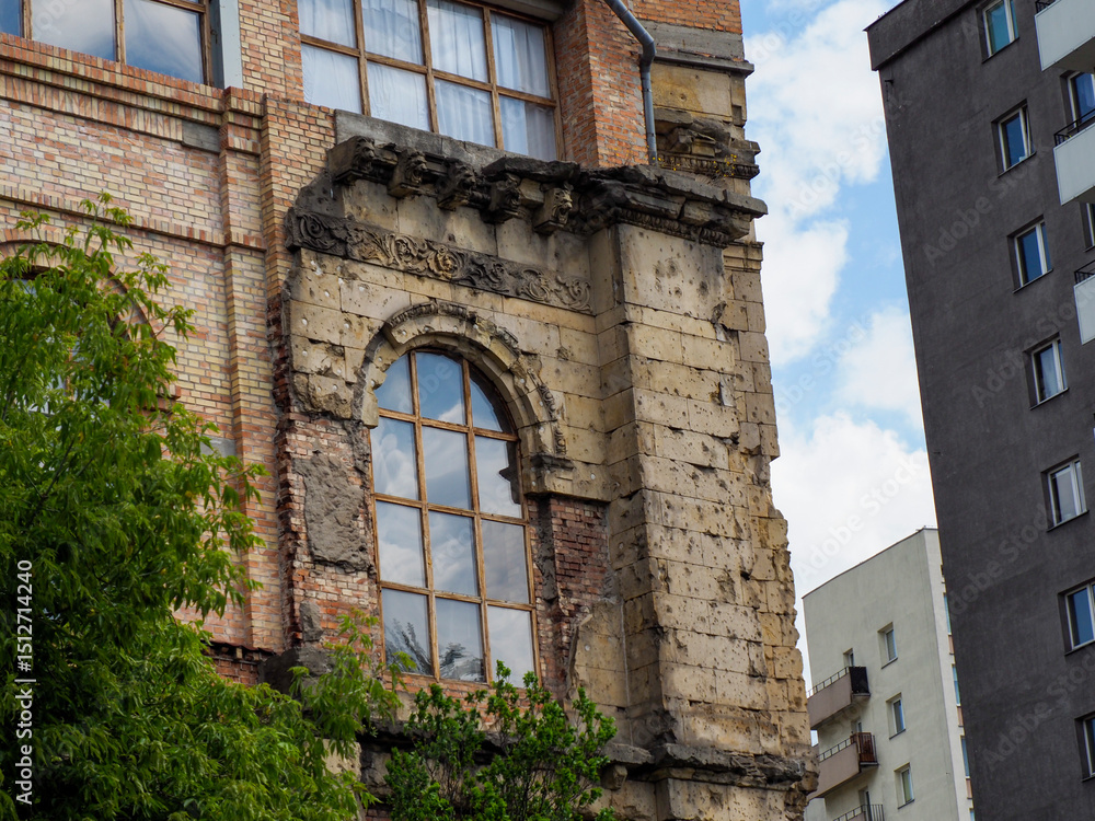 Fototapeta premium Historic brick industrial building facade with arched windows showcasing heritage architecture in urban environment