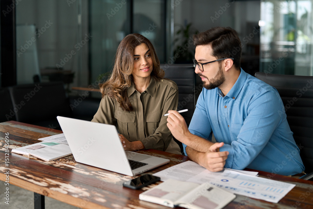 custom made wallpaper toronto digitalMiddle aged female manager teaching young male worker looking at computer discussing ai online business software at office meeting. Two busy colleagues working together talking using laptop in office.