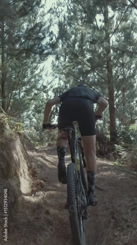 Cyclist navigates a challenging forest trail. Adventure in nature. Whakawerawera Forest, Rotorua, NZ