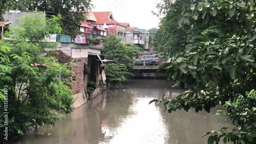 Urban Canal Lined with Historic Buildings. Scenic canal flanked by classic buildings and tree-lined banks; tranquil urban waterscape ideal for travel and architecture themes.