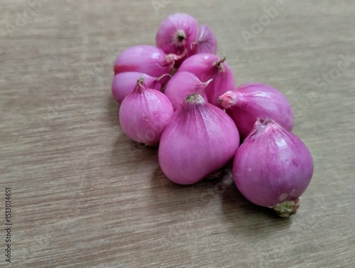red onion on wooden background. Red onion is very beneficial for health, such as maintaining the heart, lowering blood sugar, and preventing cancer.