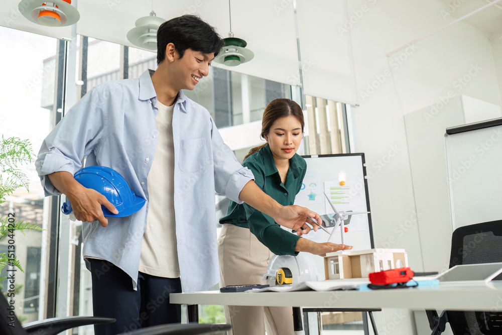 Fototapeta premium Eco-Friendly Design Collaboration. Engineers discussing sustainable building models.