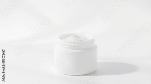 Wallpaper Mural A white, cylindrical jar with a swirl of cream on top, sitting on a white surface with soft lighting and a subtle shadow Torontodigital.ca