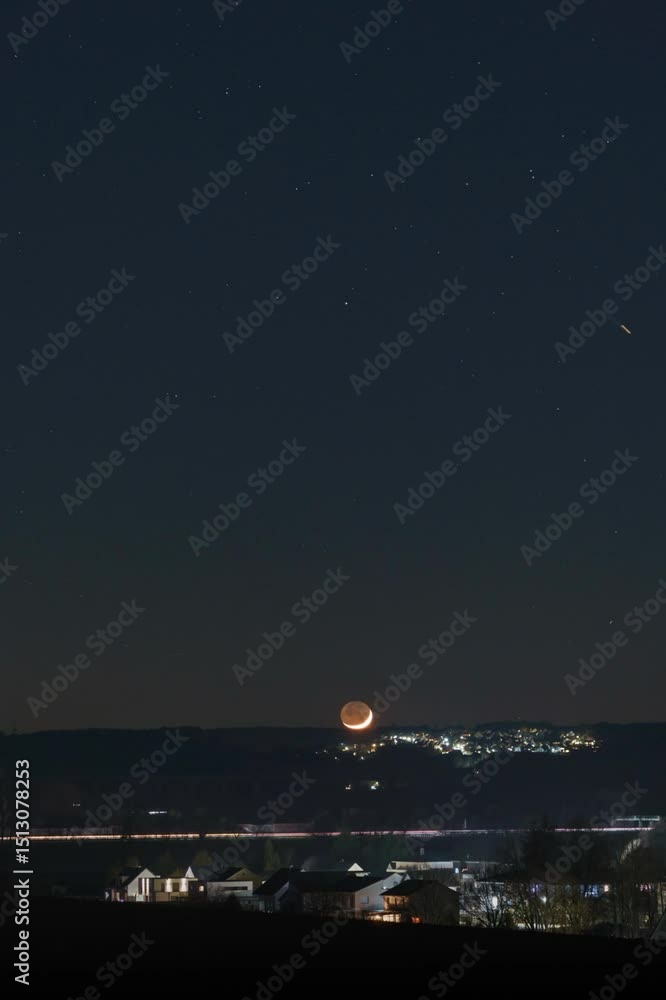 Crescent Moon over a Town at Night Crescent Moon over a Town at Night
