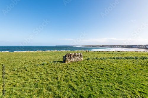 Stone bench overlooking the beach in Thurso, Caithness, Scotland, United Kingdom. Thurso Bay, also known as Scrabster Bay, is a bay of Atlantic water.