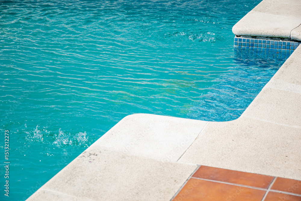 Fototapeta premium summer leisure inviting swimming pool corner with textured coping and calm water, summer background concept