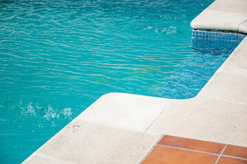 summer leisure inviting swimming pool corner with textured coping and calm water, summer background concept