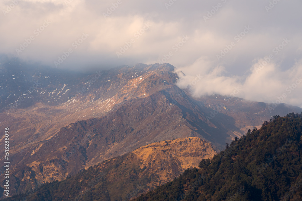 A breathtaking view of the snow-capped peaks when the clouds softly hug the mountains in great Himalayas in Nepal. A breathtaking view of the snow-capped peaks when the clouds softly hug the mountains in great Himalayas in Nepal.
