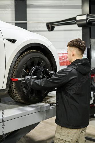 Wheel alignment at a car service station. Tire center. Modern repair equipment.