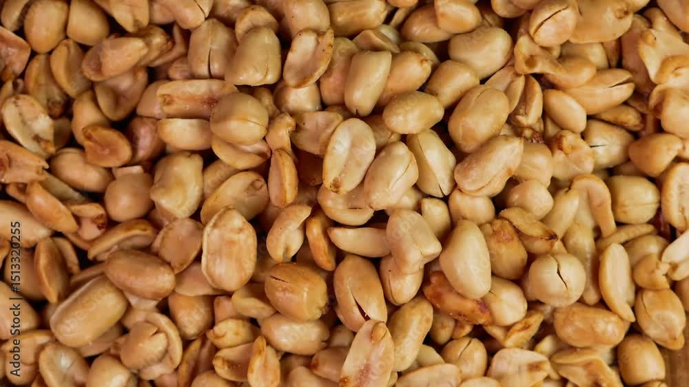 Slow motion of delicious roasted peanuts being peeled. Perfect for advertising or promotion. Top view horizontal shot Slow motion of delicious roasted peanuts being peeled. Perfect for advertising or promotion. Top view horizontal shot