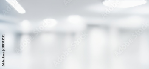 Blurred abstract background of a bright white interior space with lights.