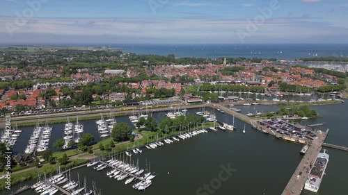 Aerial drone footage of historic picturesque Dutch city Enkhuizen with boats and yachts Netherlands harbor port water Ijsselmeer on sunny summer day