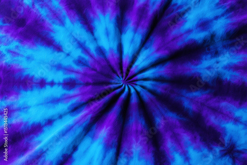Vibrant tie dye pattern with blue and purple spiral design