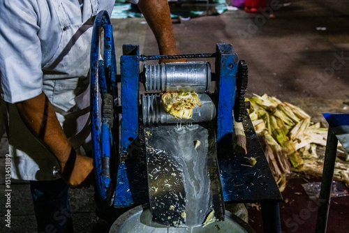 Preparing sugarcane juice at the Forodhani gardens in Stone town at night. Zanzibar, Tanzania