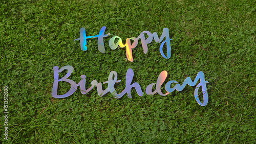 Photography Happy birthday celebration with colorful letters on grass