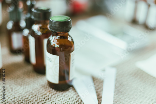 Foto Shot of mature perfumer adding extra essential oil