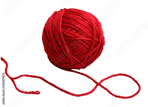 A single red yarn ball with a loose end isolated against a black background in a studio shot image