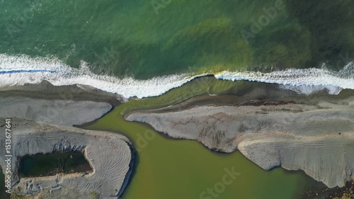 Discover an enchanting landscape along the Adjara coastline in Georgia, where the vibrant river flows into the vast Black Sea, intricately shaping the shoreline.