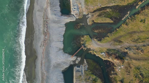 Discover an enchanting landscape along the Adjara coastline in Georgia, where the vibrant river flows into the vast Black Sea, intricately shaping the shoreline.