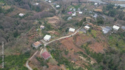 Explore the stunning landscape of Adjara, Georgia. This captivating aerial view reveals winding rivers, lush fields, and vibrant neighborhoods. Experience the natural beauty and tranquil environment.