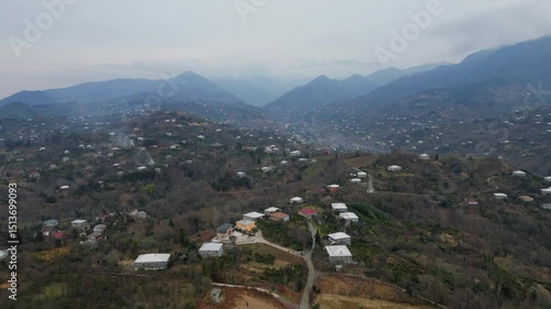 Explore the stunning landscape of Adjara, Georgia. This captivating aerial view reveals winding rivers, lush fields, and vibrant neighborhoods. Experience the natural beauty and tranquil environment.