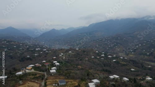 Explore the stunning landscape of Adjara, Georgia. This captivating aerial view reveals winding rivers, lush fields, and vibrant neighborhoods. Experience the natural beauty and tranquil environment.