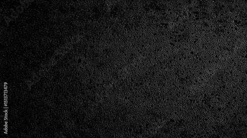 Black foam rubber texture background with a rough surface