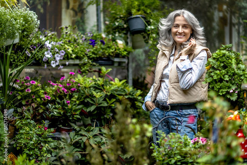 Portrait of a 50 year old woman in the yard of an ornamental flower store