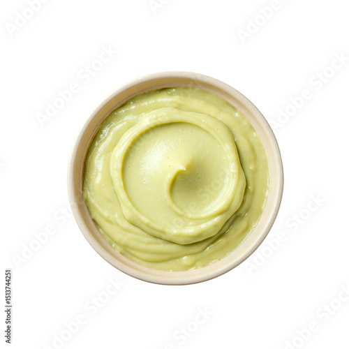 Top view of a ceramic bowl filled with creamy green avocado spread, isolated on a transparent background