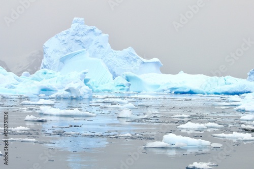 Melting Antarctic Ice Formation Under Pink-Grey Sky
