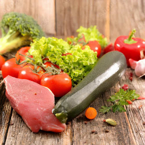 fresh meat and vegetables on wooden board