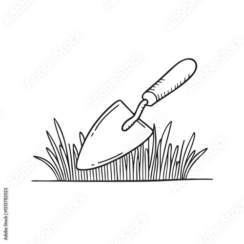 A trowel near trimmed grass