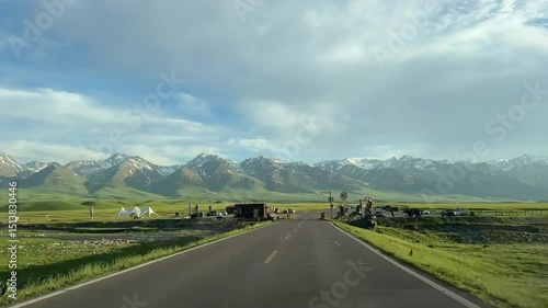 Scenic Mountain Landscape
Description: Snow-capped mountains under blue sky with a green valley in the foreground.
