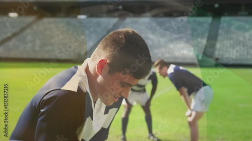 Rugby player lifting head, inhaling, calling teammates on grass pitch, rallying pack for next play