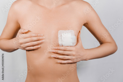 Obraz na plátně woman's breast covered with adhesive tape after surgery to correct a congenital anomaly